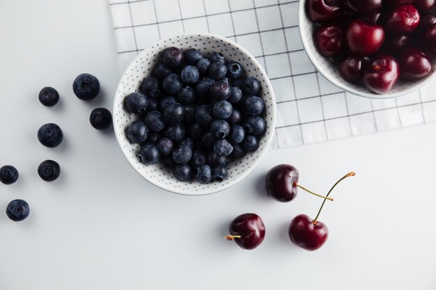 Close up of cherries and blueberries in bowls