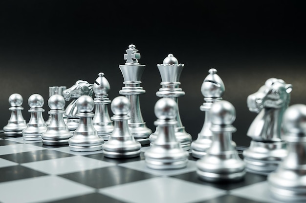 Close-up of chess pieces on board against black background