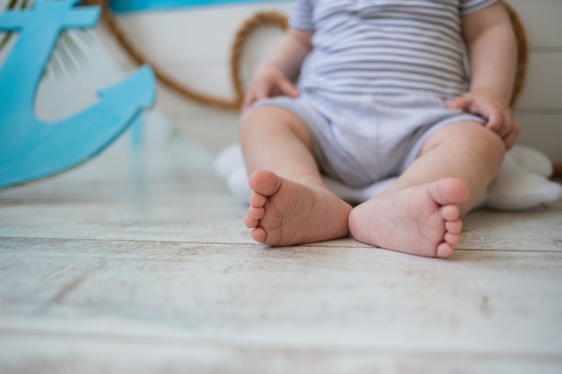 Close-up of a child's bare feet on a wooden floor with room for text