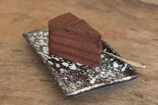 Close up of Chocolate cake sliced on wooden desk