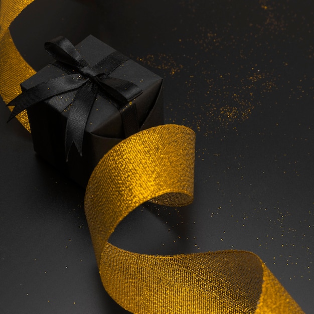 Close-up of christmas present with golden ribbon