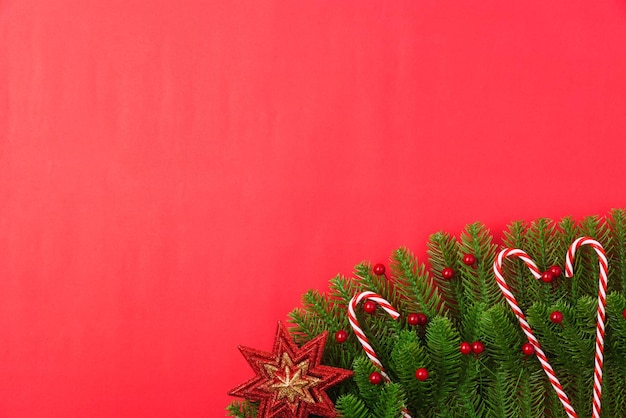 Close-up of christmas tree against red background