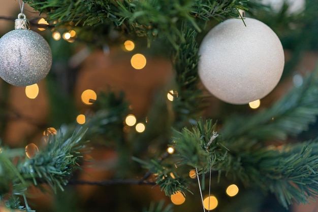 Close-up of Christmas tree with balls, stars and Christmas lights decoration