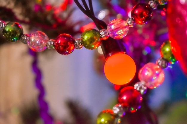 A close up of a christmas tree with colorful lights