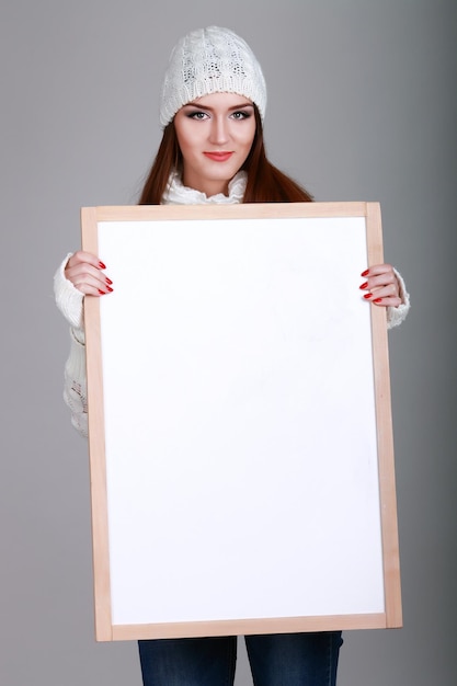 Close up christmas woman portrait behind big white card Emotion portrait Isolated