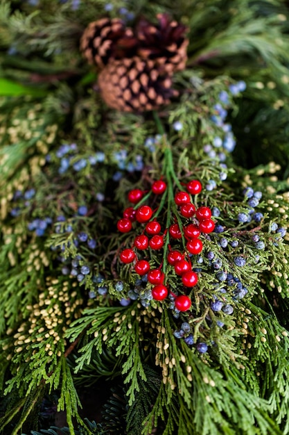 Close up of Christmas wreath decorated with pinecones and berries.