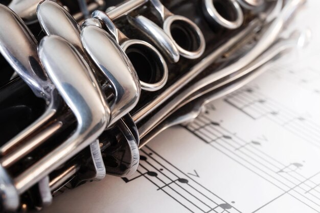 Photo close-up of clarinet on musical notes