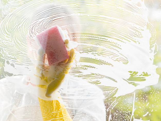 Close-up cleaner washing the window with sponge