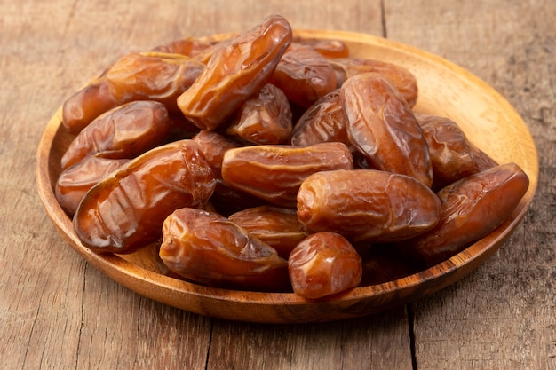 Close up of cluster dates plam. Fresh dates plam on wooden table.