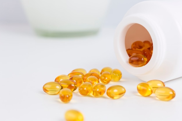 Close up on cod oil capsules on wooden table