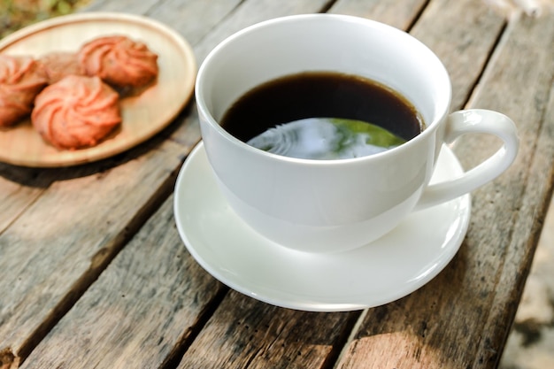 Close-up of coffee and cookies on table