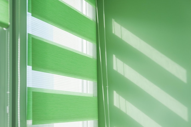 Photo close up of colored fabric roller blinds on window. roll curtains.