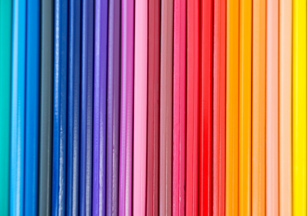 Close-up of colored pencil arranged in a row