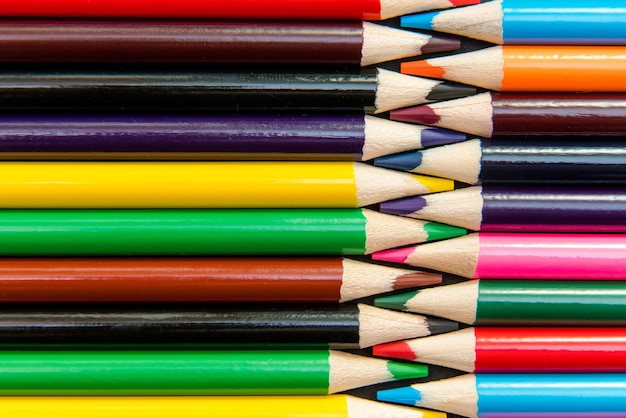 Close-up of colored pencils arranged in interlock pattern.