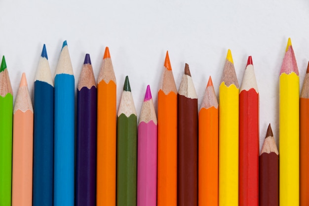 Close-up of colored pencils arranged in a wave pattern