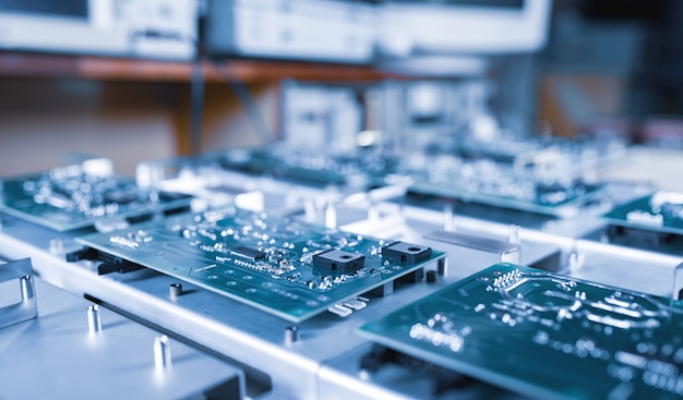 Close-up computer green microcircuits lie row after row in the industrial production of computers and office equipment. Concept of developing new technologies and storing information