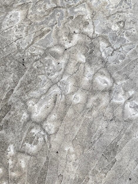 A close up of a concrete wall with a pattern of circles and lines.