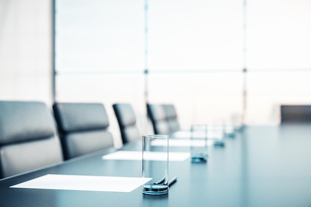 Close up of conference room with glasses of water on the table with papers armchairs and a large window 3D Rendering