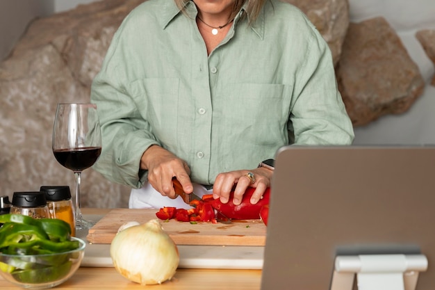 Close up cook cutting pepper