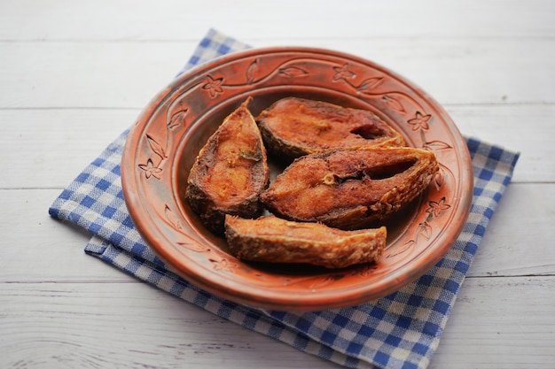 Close up of cooked ilsha fish on plate on table