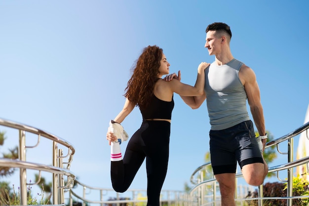 Close up of couple stretching legs outdoors