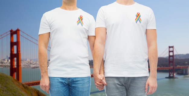 close up of couple with gay pride rainbow ribbons