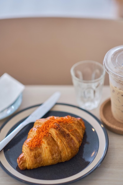 Close-up of croissant in plate on table