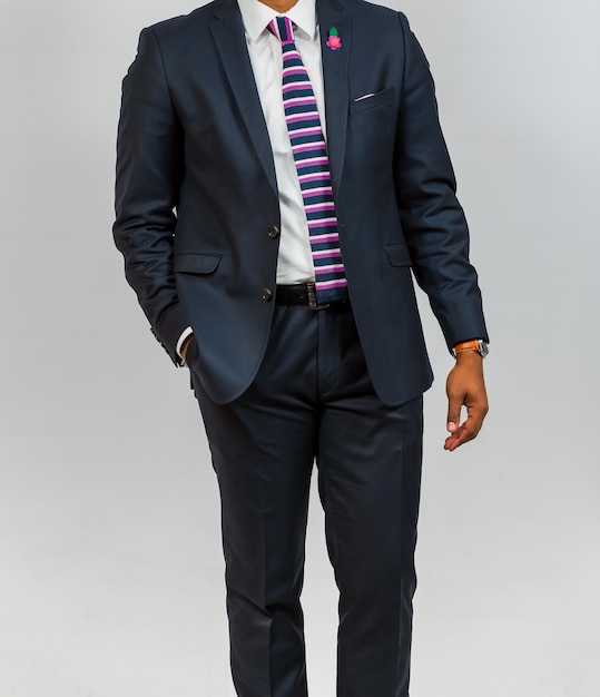 Close-up cropped African Black hands and arms of businessman in a suit with hand in pocket