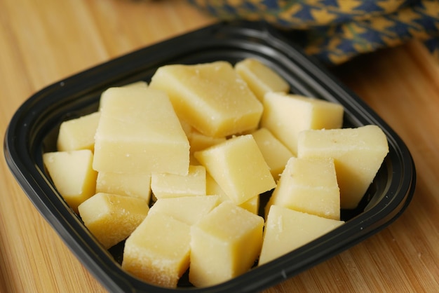 Close up of cube shape fresh cheese on in a bowl