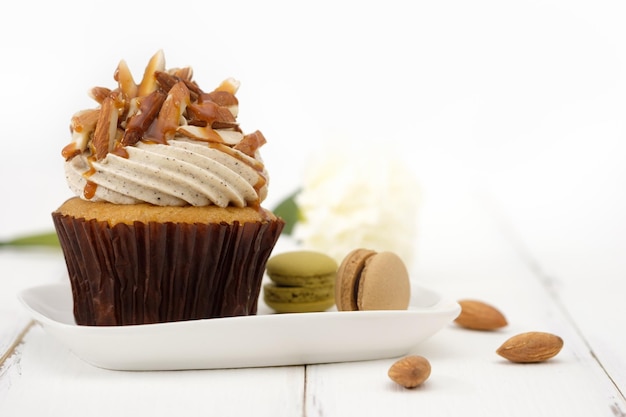 Close-up of cupcake with macaroons on table