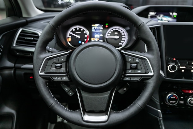 Close-up of the dashboard, speedometer, tachometer and steering wheel. . modern car interior