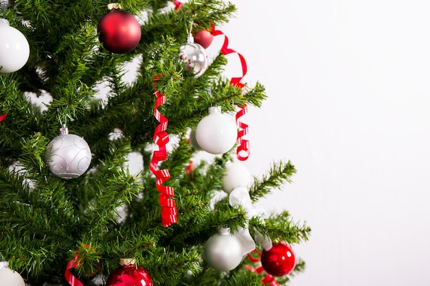 Close up of decorated Christmas tree over white