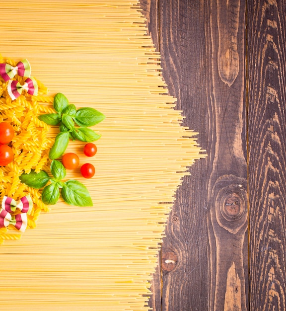 Close-up of decorating Italian pasta. On a wooden background