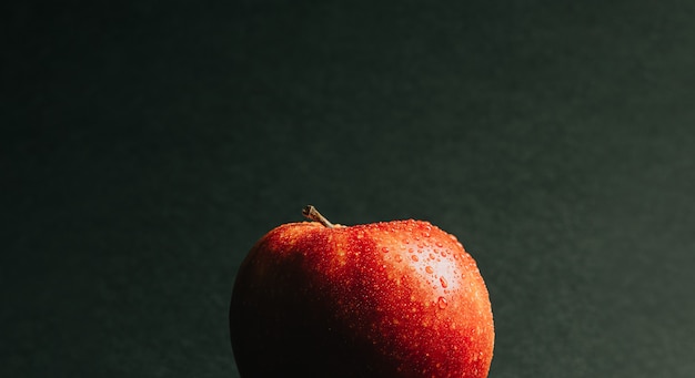 Close up of a delicious apple with some water drops over it