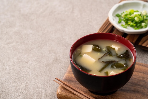 Close up of delicious savory Japanese miso soup in a black bowl for eating