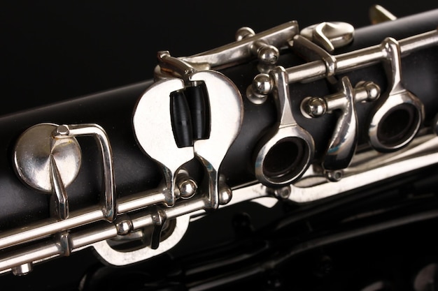 Close up detail of clarinet on black background