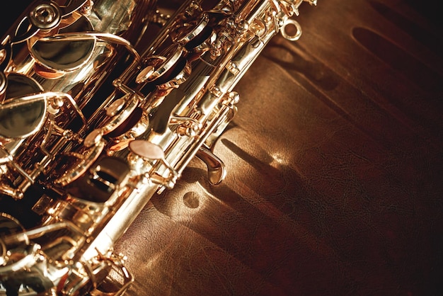 Close up and detailed view of a shiny keys of a golden saxophone lying on