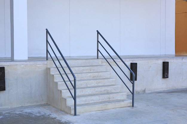 Close-up details of stairs and railing of a building.