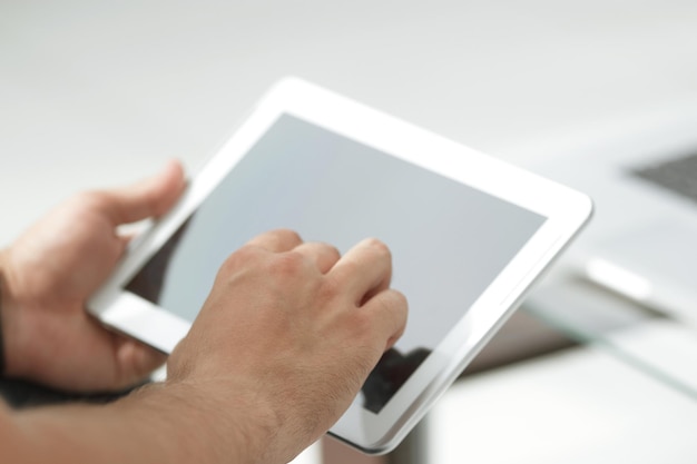 Close up digital tablet in the hands of a businessman