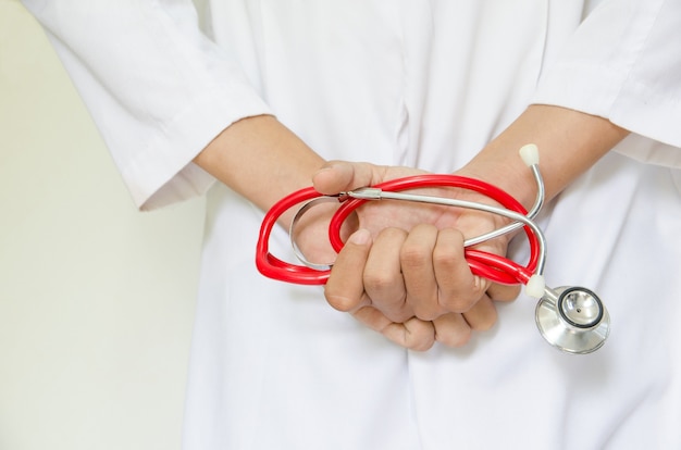 close up of doctor holding stethoscope on back