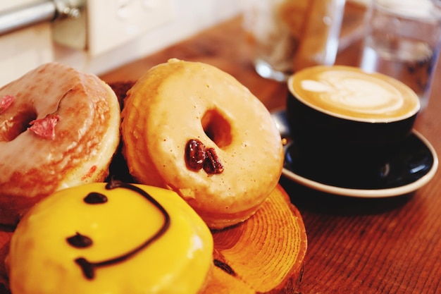 Close-up of donuts by coffee on table