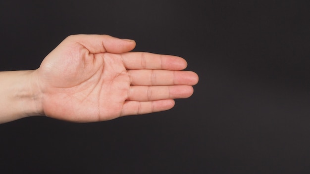 Close up of empty left hand palm and Finger close on black background.