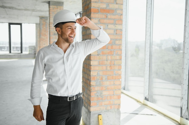 Close up engineers working on a building site holding a blueprints.Engineering and architecture concept