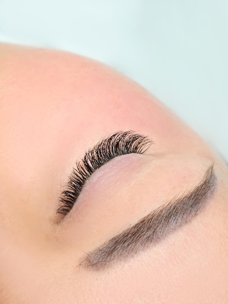 Close up of eye with eyelash extensions in beauty salon macro eye top view