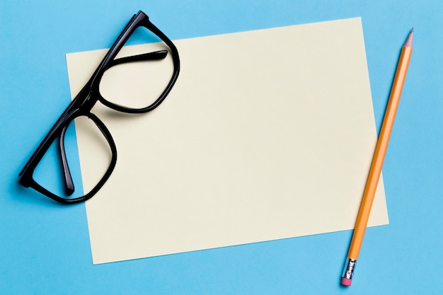 Close-up eyeglasses with paper and pencil