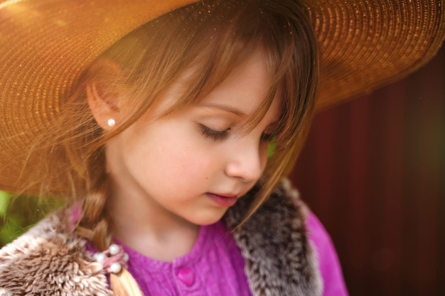 Close up face of girl in straw hat in Garden Girl with long hair in springtime Gardening