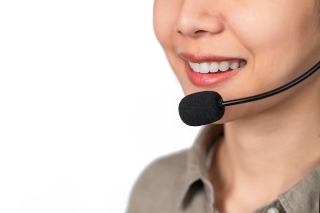 Close up of face smiling woman wear headset is customer support phone operator Consulting service call center on grey background