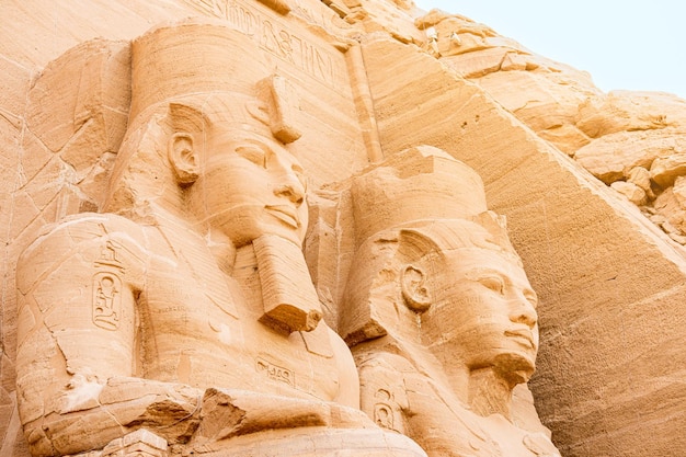 Close up of the faces of two ancient Egyptian statues