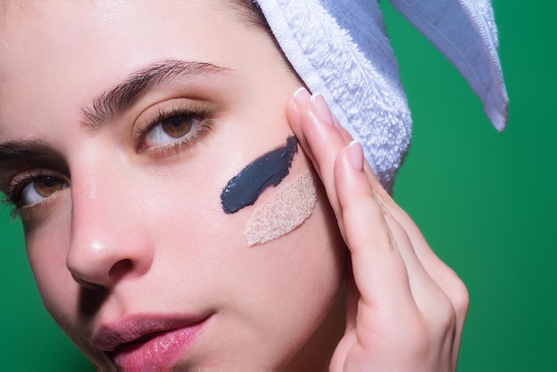 Close up facial cream on cheek skin care beauty portrait of a beautiful woman applying face cream is