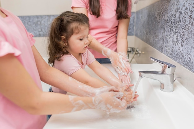 Close-up family washing hands